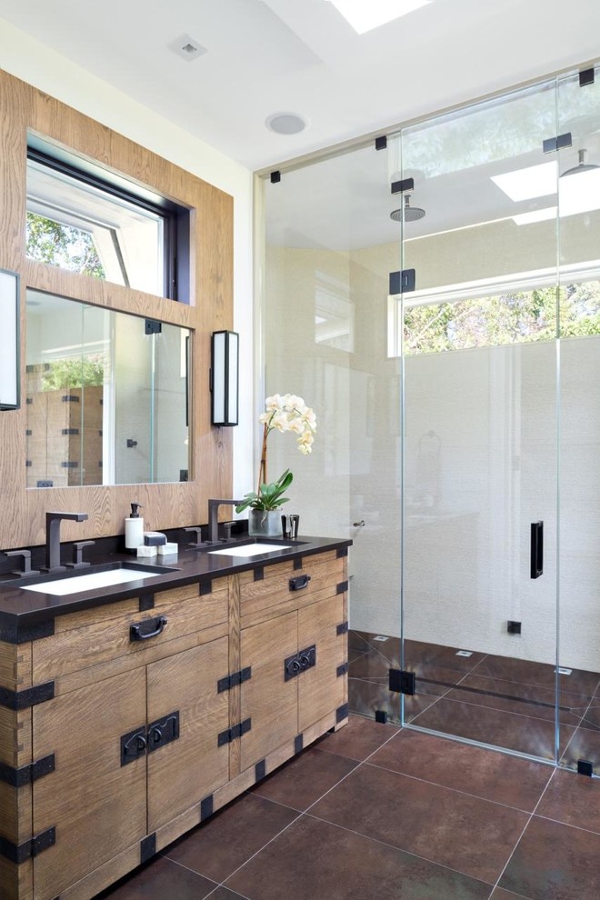 This is an example of a mid-sized beach style master bathroom in New York with light wood cabinets, an undermount sink, brown floor, a hinged shower door, a double shower, beige walls, slate floors and flat-panel cabinets.