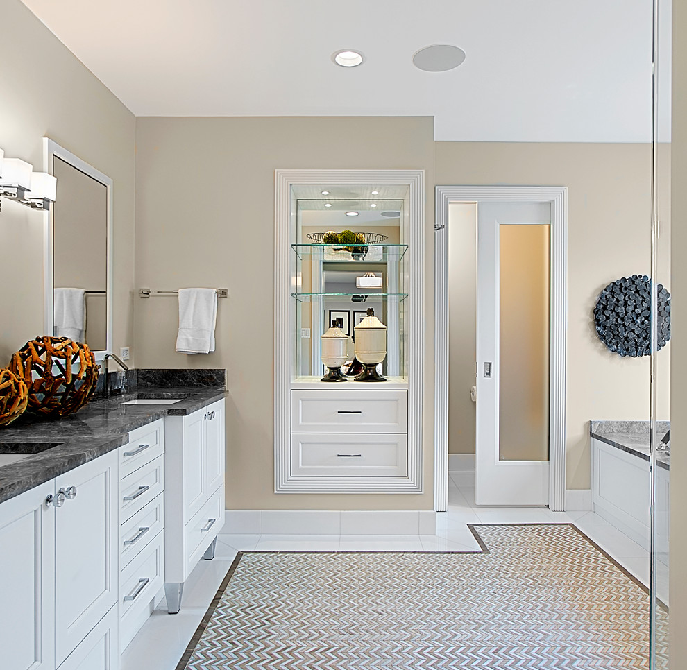 Design ideas for a mid-sized transitional master bathroom in Chicago with recessed-panel cabinets, white cabinets, multi-coloured tile, mosaic tile, beige walls, marble floors, marble benchtops, an alcove tub, an undermount sink, multi-coloured floor, black benchtops, a double vanity and a built-in vanity.