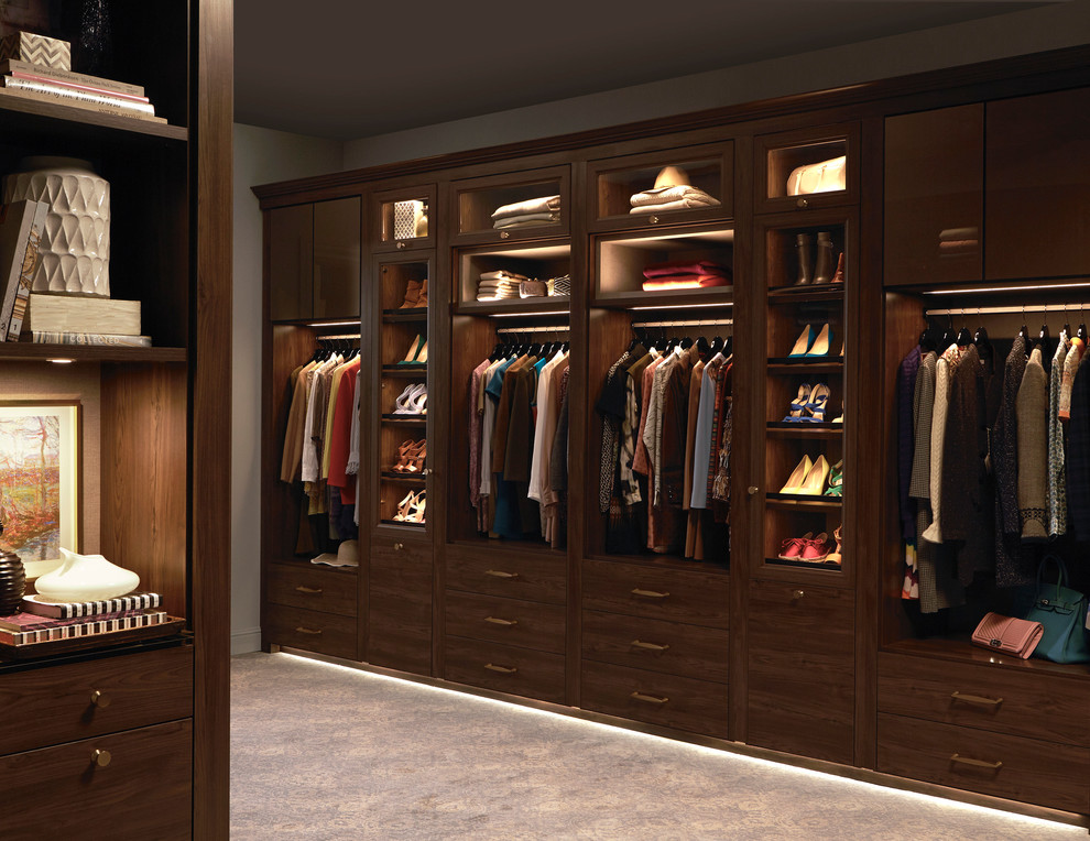 Design ideas for an expansive transitional gender-neutral walk-in wardrobe in Other with glass-front cabinets.