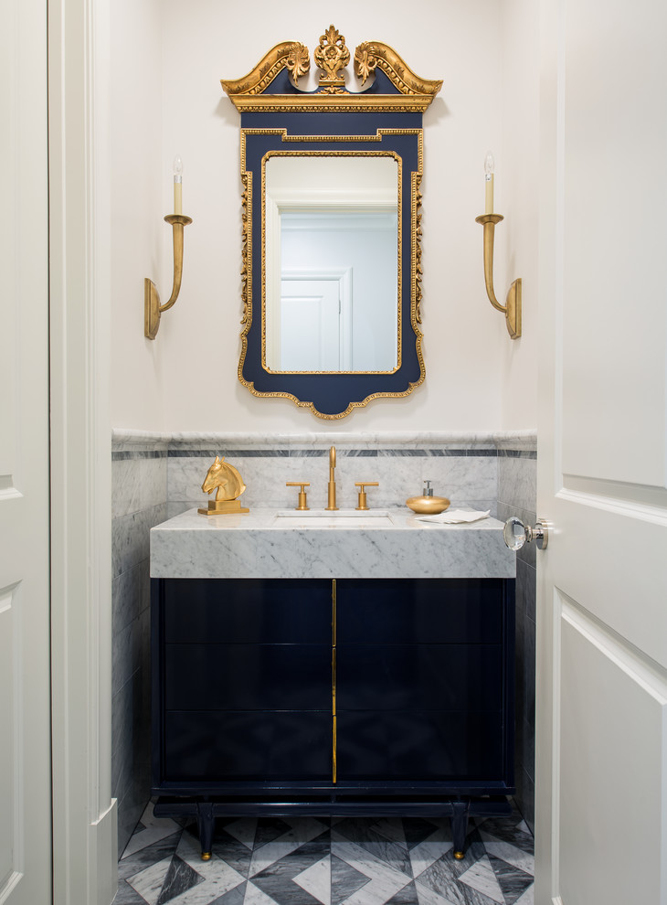 Transitional powder room in Dallas with an undermount sink, furniture-like cabinets, blue cabinets, quartzite benchtops, stone tile, white walls, marble floors, gray tile and grey benchtops.