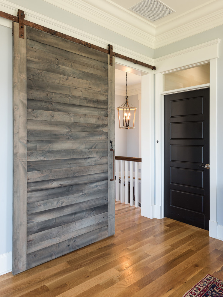 Inspiration for a mid-sized country hallway in Other with grey walls, dark hardwood floors and brown floor.
