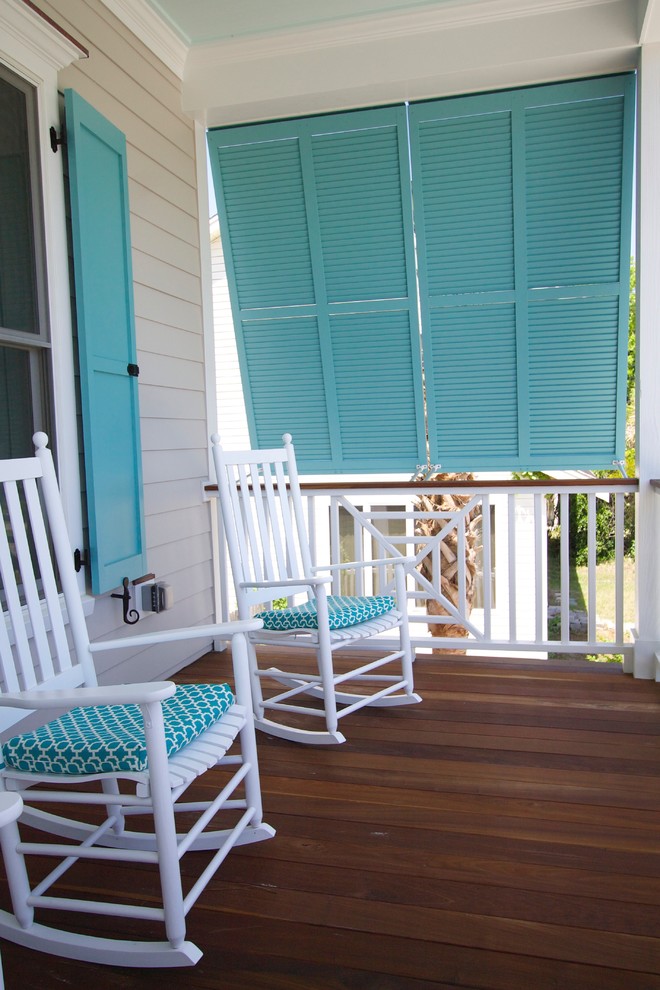 This is an example of a mid-sized beach style front yard verandah in Charlotte with decking and a roof extension.