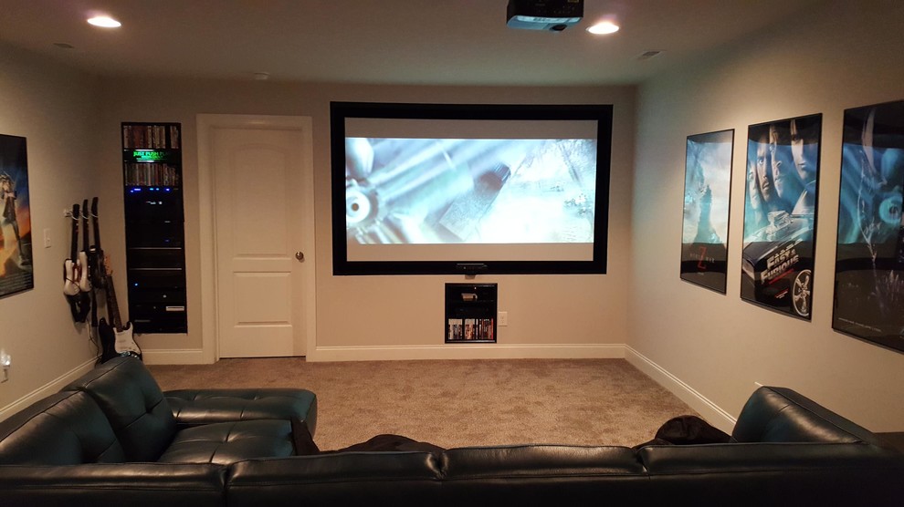 Mid-sized modern enclosed home theatre in Raleigh with grey walls, carpet, a projector screen and grey floor.