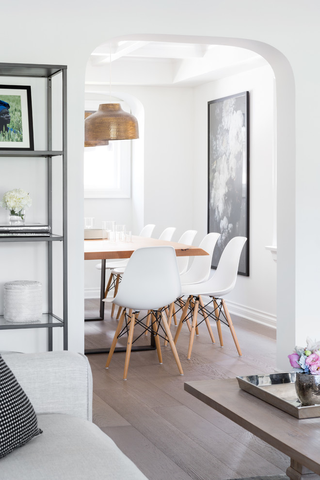 Small transitional light wood floor enclosed dining room photo in Vancouver with white walls and no fireplace