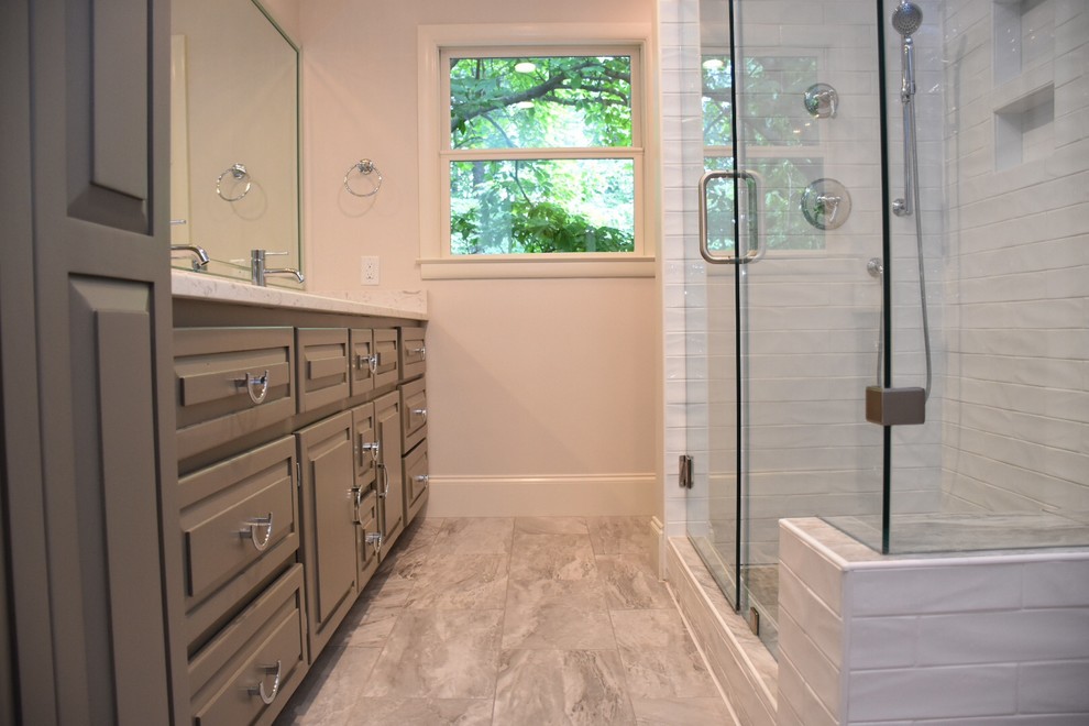 Mid-sized transitional master bathroom in Other with raised-panel cabinets, grey cabinets, an alcove shower, a two-piece toilet, white tile, subway tile, white walls, ceramic floors, an undermount sink, quartzite benchtops, green floor and a hinged shower door.