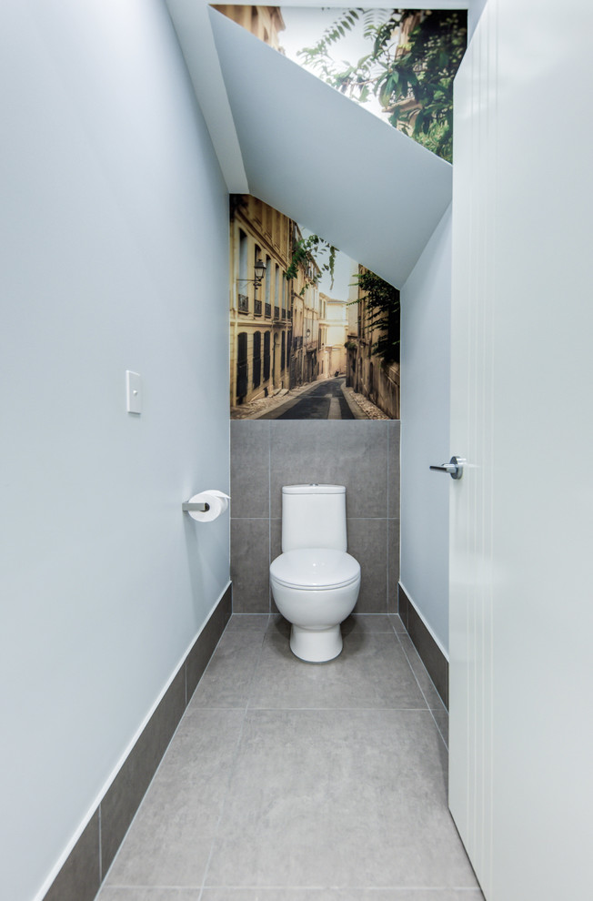 Inspiration for a small contemporary powder room in Sunshine Coast with blue walls, ceramic floors, grey floor, a one-piece toilet, gray tile and porcelain tile.