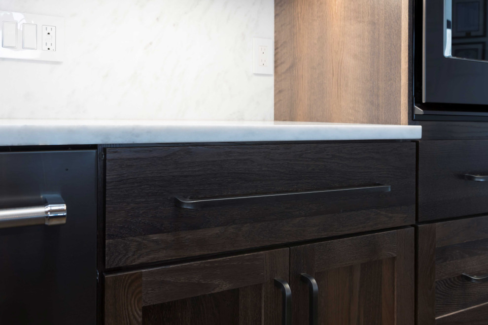 Open concept kitchen - huge transitional single-wall dark wood floor, brown floor and shiplap ceiling open concept kitchen idea in Denver with a farmhouse sink, shaker cabinets, dark wood cabinets, marble countertops, paneled appliances, an island and white countertops