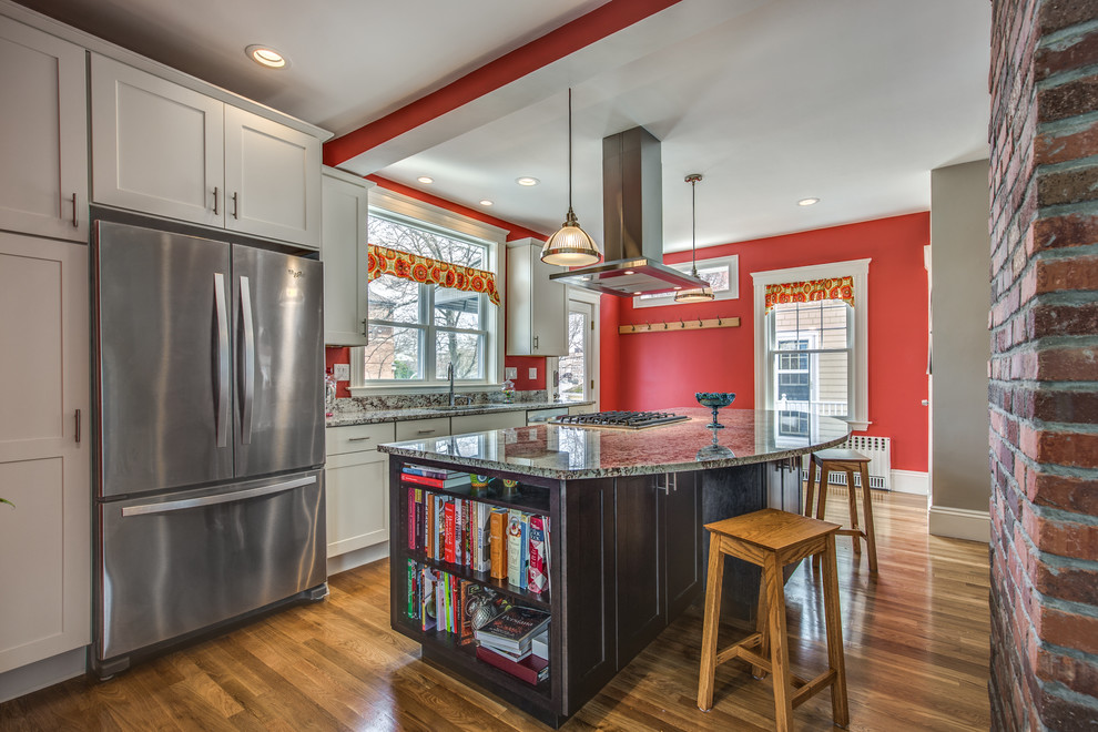 Example of a mid-sized transitional galley light wood floor and beige floor eat-in kitchen design in Boston with an undermount sink, shaker cabinets, white cabinets, granite countertops, red backsplash, stainless steel appliances and an island