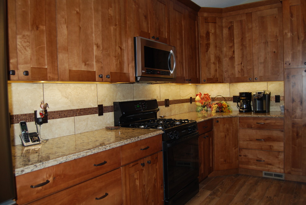 Inspiration for a mid-sized rustic l-shaped porcelain tile and brown floor eat-in kitchen remodel with an undermount sink, beaded inset cabinets, medium tone wood cabinets, beige backsplash, porcelain backsplash, quartz countertops, stainless steel appliances and an island