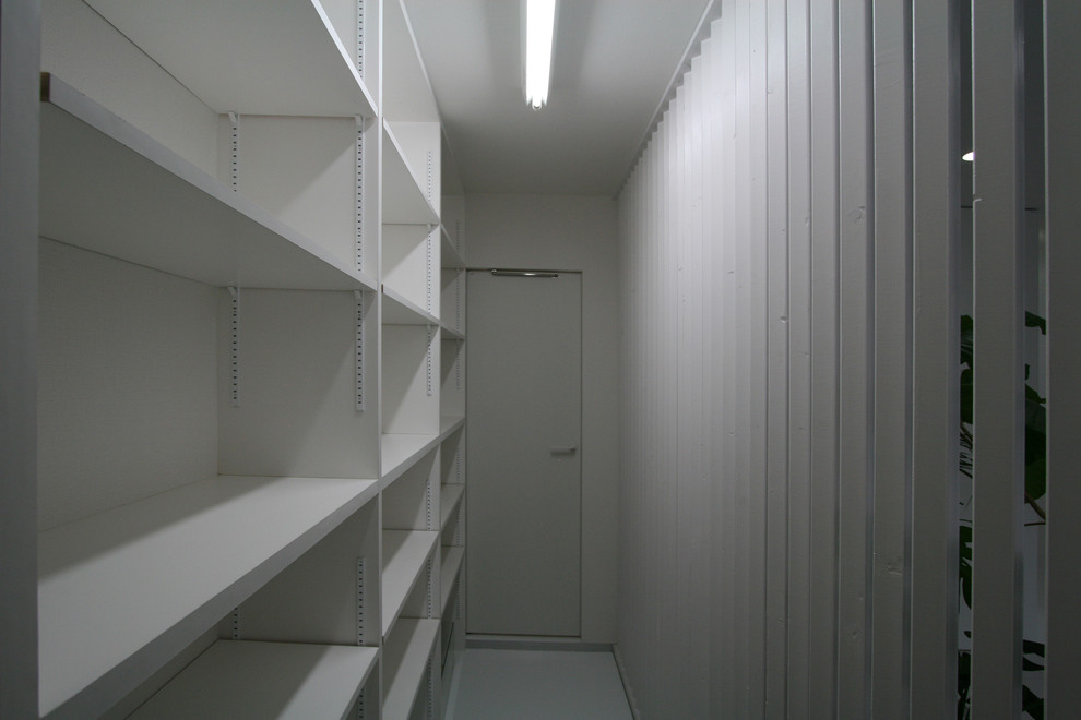 Inspiration for a large modern walk-in wardrobe in Tokyo with vinyl floors, white floor and white cabinets.
