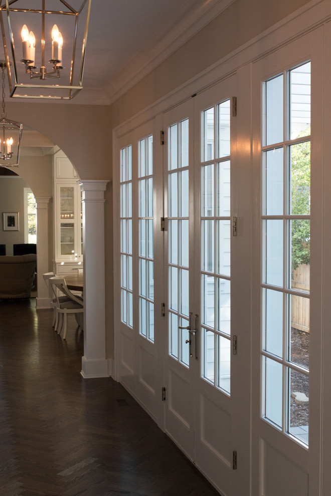 Mid-sized transitional medium tone wood floor and brown floor hallway photo in Chicago with beige walls