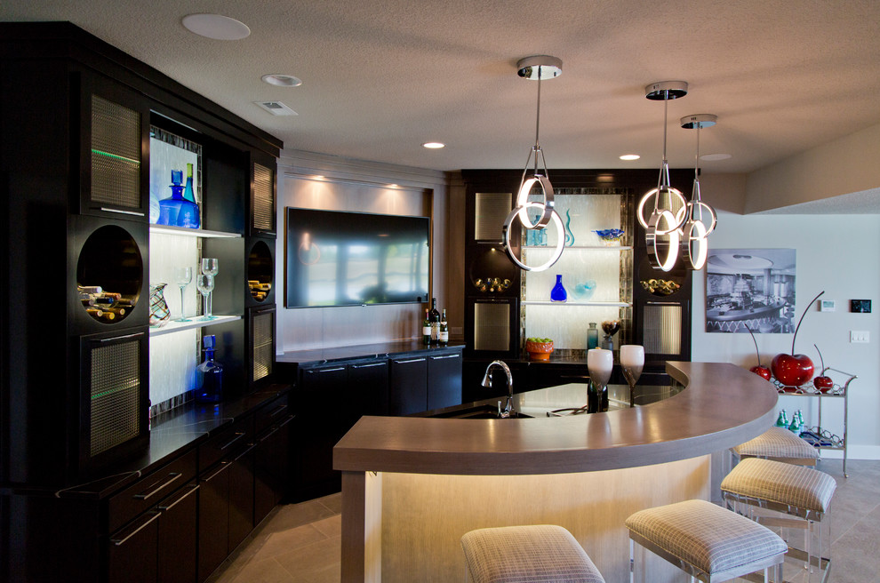 Photo of a large transitional single-wall seated home bar in Kansas City with glass-front cabinets, black cabinets, grey splashback, ceramic floors, beige floor and grey benchtop.