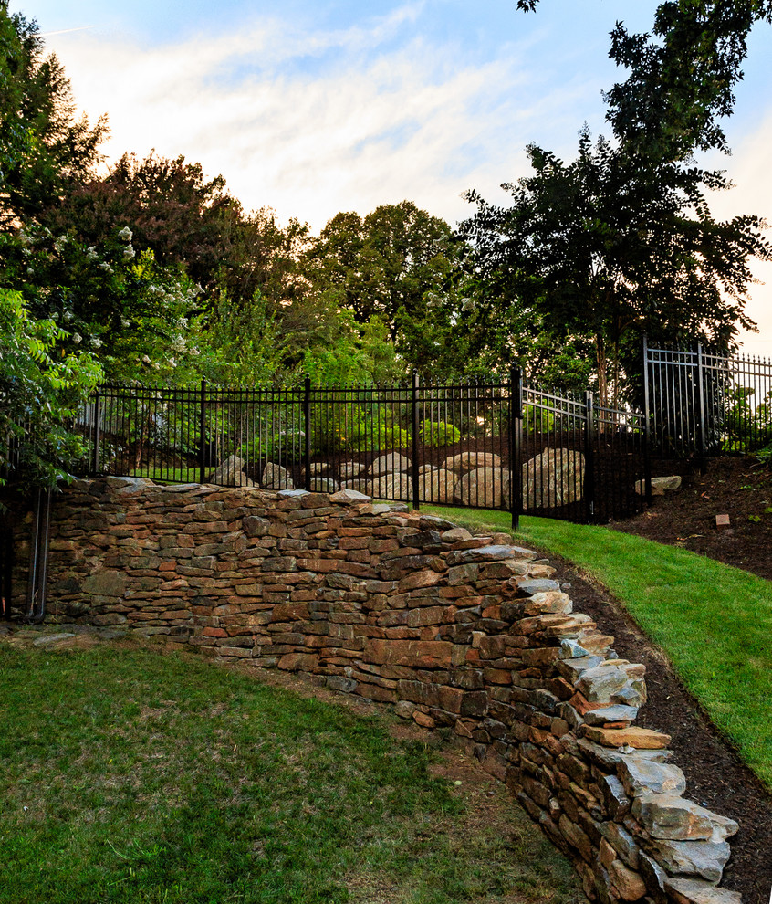 Example of a backyard stone and rectangular hot tub design