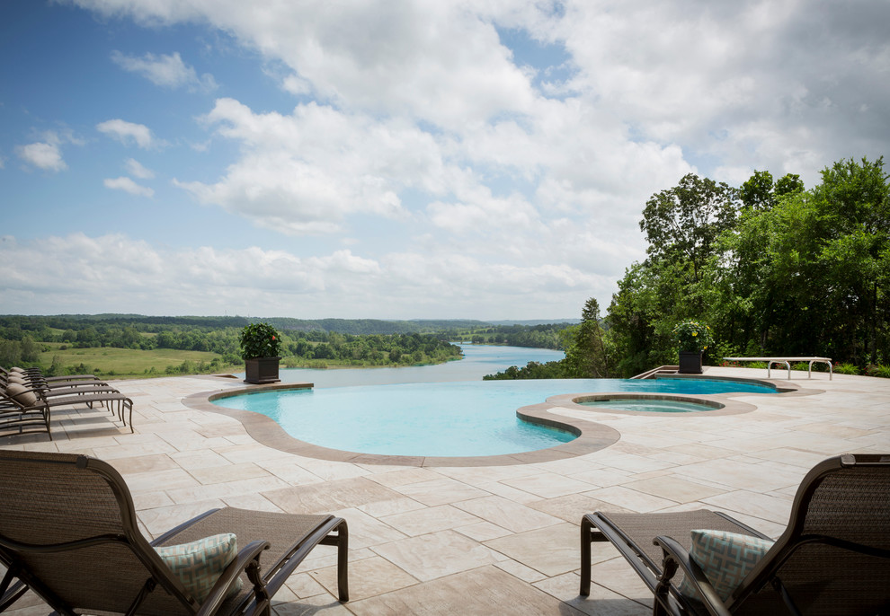 Hot tub - large transitional backyard stone and custom-shaped infinity hot tub idea