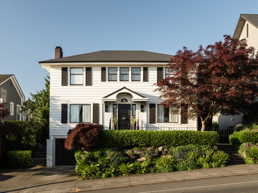 Inspiration for a traditional three-storey white house exterior in Seattle with a hip roof, a shingle roof, a grey roof and clapboard siding.