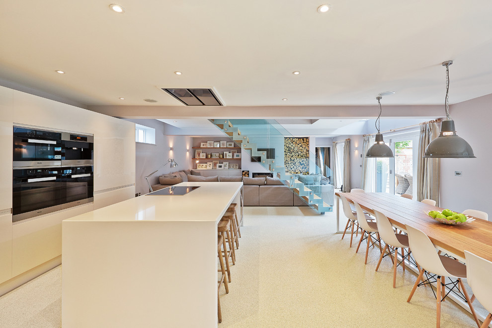 Photo of a contemporary open plan kitchen in Other with flat-panel cabinets, white cabinets and with island.