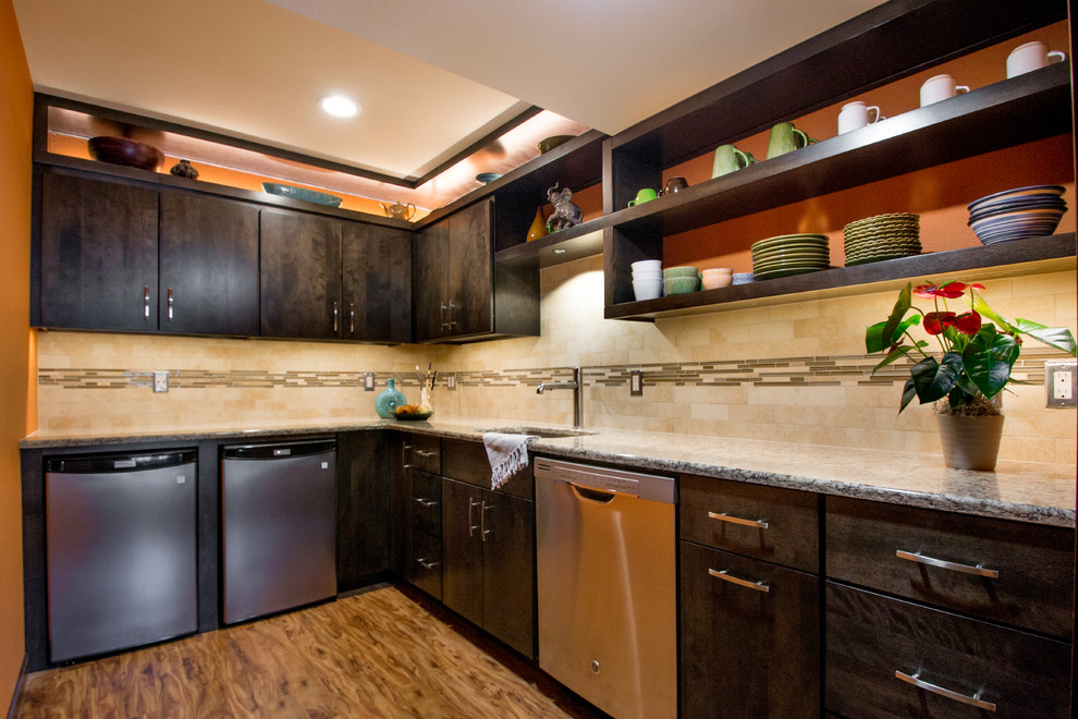 Example of a small minimalist l-shaped vinyl floor and brown floor enclosed kitchen design in Cedar Rapids with an undermount sink, flat-panel cabinets, dark wood cabinets, beige backsplash, stainless steel appliances, granite countertops, subway tile backsplash and gray countertops