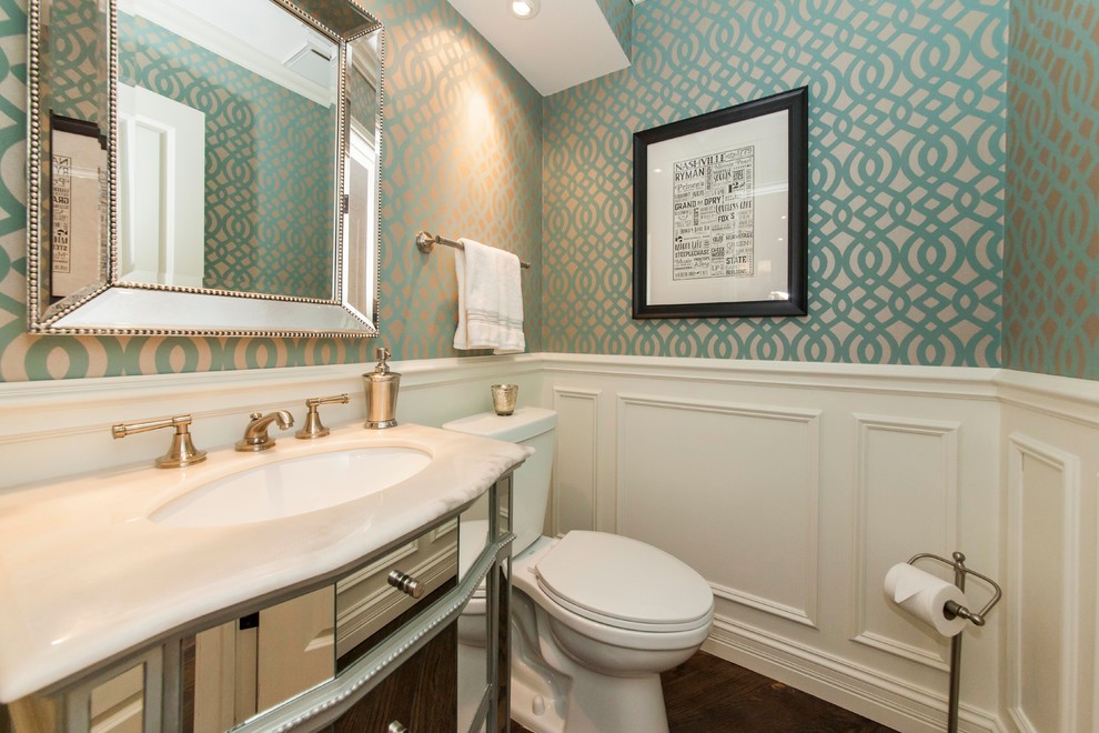 Small traditional powder room in Chicago with an undermount sink, glass-front cabinets, grey cabinets, marble benchtops, a two-piece toilet, multi-coloured walls and dark hardwood floors.