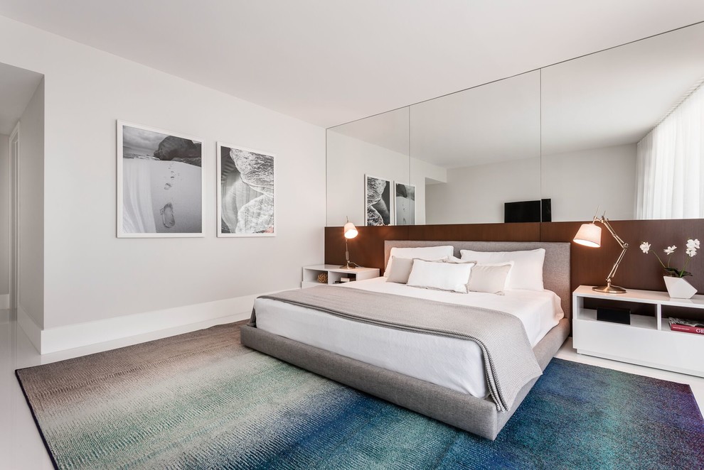 Large contemporary master bedroom in Miami with white walls, porcelain floors, no fireplace and white floor.
