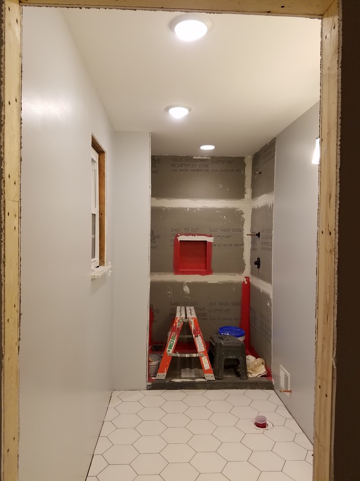 Inspiration for a small transitional 3/4 blue tile and glass tile porcelain tile alcove shower remodel in Cincinnati with recessed-panel cabinets, black cabinets, a two-piece toilet, gray walls, an undermount sink and quartz countertops