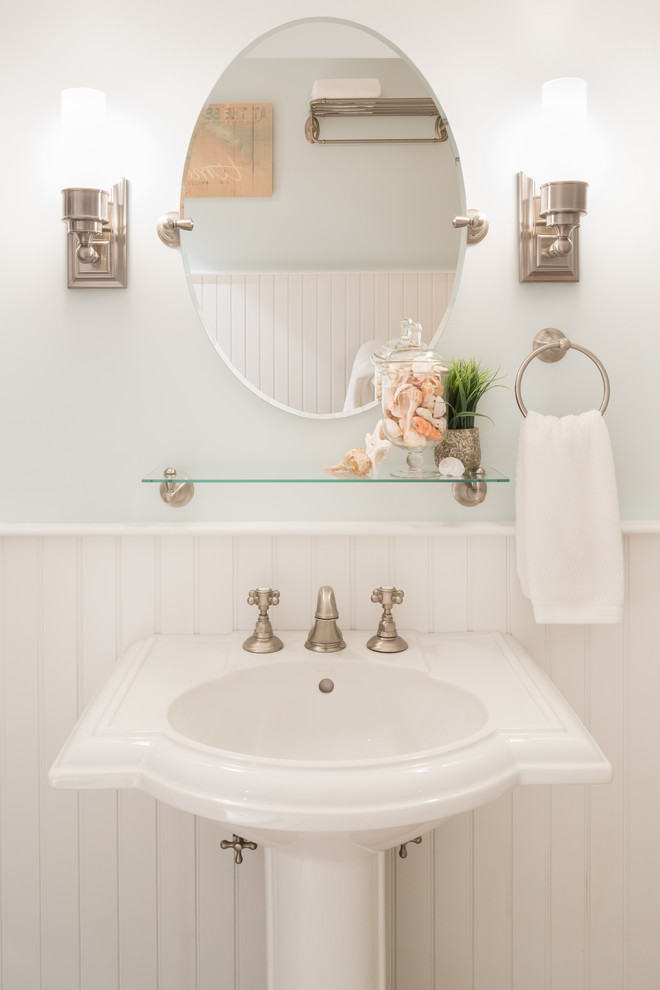 Inspiration for a mid-sized beach style 3/4 bathroom in Boston with open cabinets, a claw-foot tub, blue walls, medium hardwood floors, a pedestal sink, solid surface benchtops and brown floor.