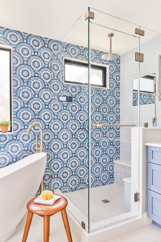 Inspiration for a mid-sized contemporary master bathroom in Austin with a freestanding tub, a corner shower, blue tile, glass tile, blue walls and a hinged shower door.