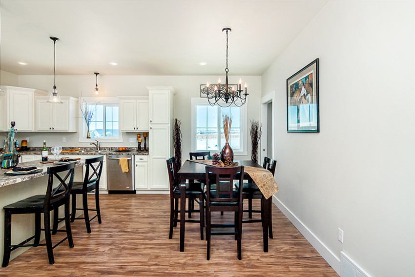Mid-sized transitional l-shaped medium tone wood floor open concept kitchen photo with an undermount sink, recessed-panel cabinets, white cabinets, granite countertops, stainless steel appliances and an island