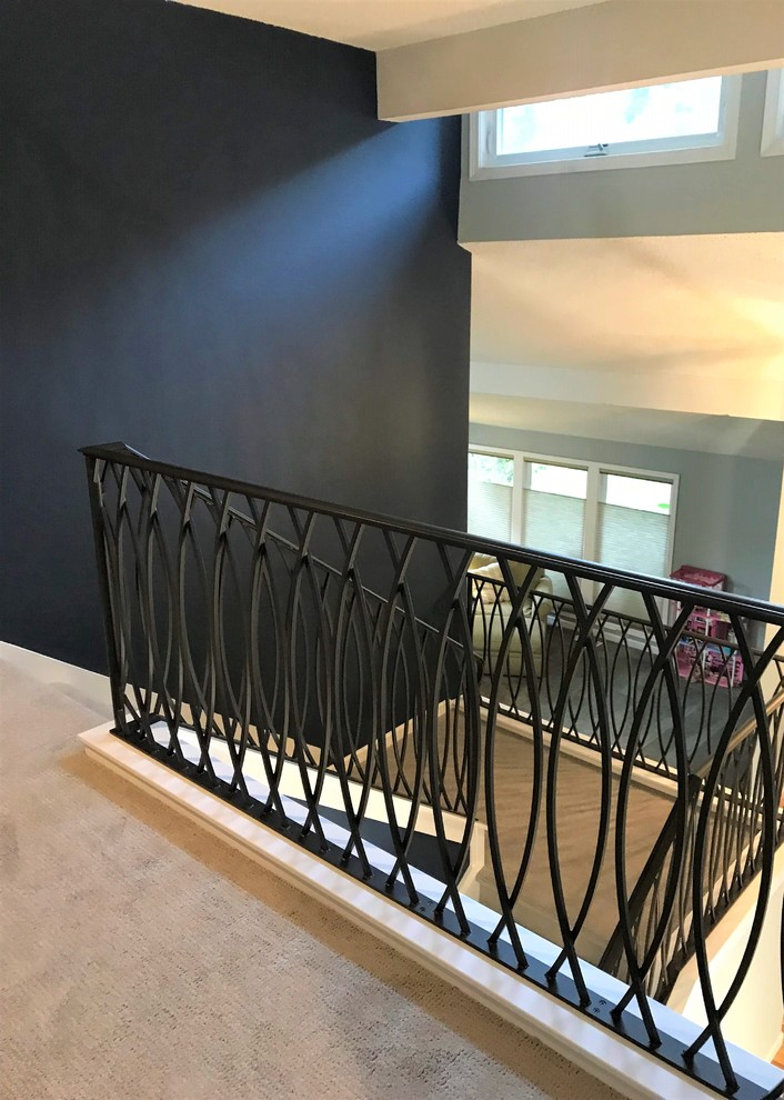 Staircase - mid-sized transitional carpeted u-shaped metal railing staircase idea in Seattle with carpeted risers