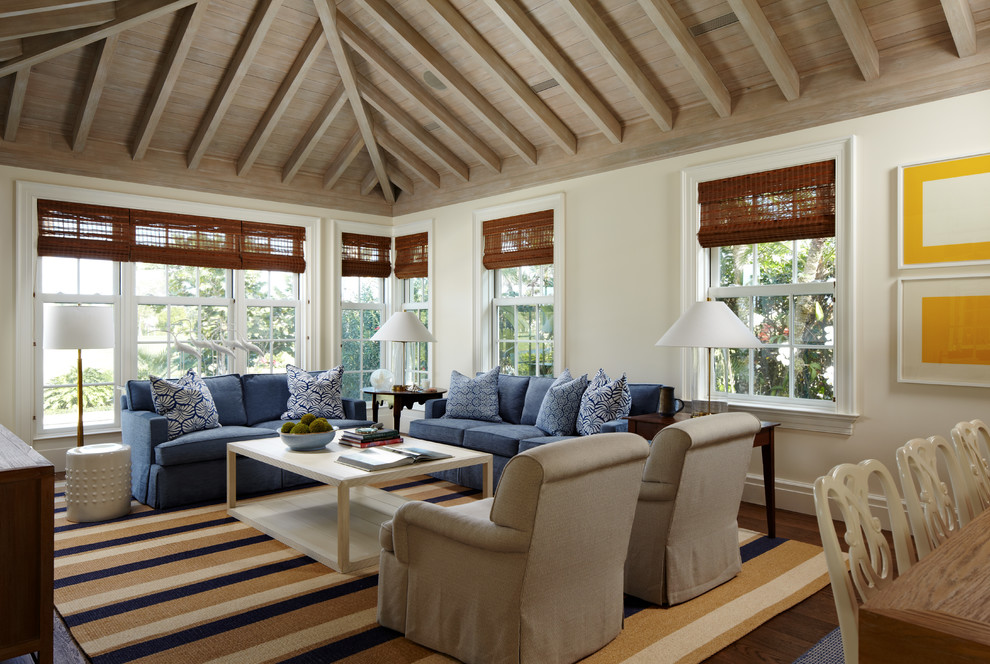 Design ideas for a tropical open concept living room in Miami with white walls and dark hardwood floors.