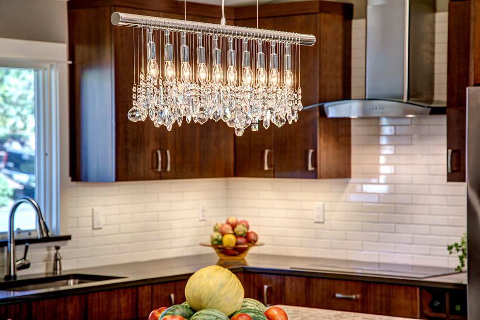 Small transitional l-shaped medium tone wood floor eat-in kitchen photo in Seattle with a single-bowl sink, flat-panel cabinets, dark wood cabinets, quartz countertops, white backsplash, ceramic backsplash, stainless steel appliances and an island