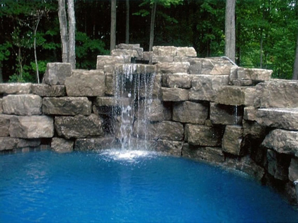 Design ideas for a mid-sized traditional backyard custom-shaped lap pool in Toronto with a water feature and decomposed granite.