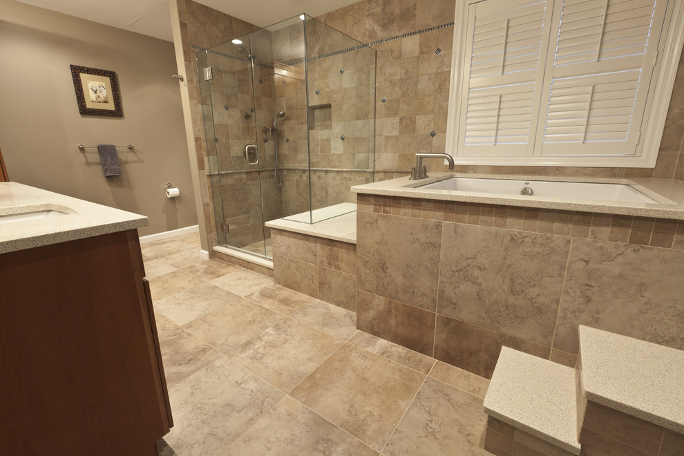 Large traditional master bathroom in Bridgeport with an undermount sink, recessed-panel cabinets, medium wood cabinets, engineered quartz benchtops, a japanese tub, a corner shower, a two-piece toilet, beige tile, porcelain tile, beige walls and porcelain floors.