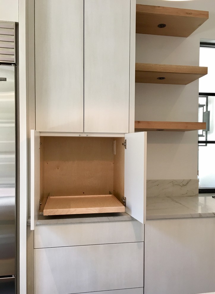 Kitchen pantry - concrete floor and gray floor kitchen pantry idea with an undermount sink, flat-panel cabinets, gray cabinets, marble countertops, stainless steel appliances, an island and gray countertops