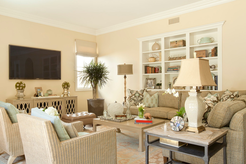 Inspiration for a traditional family room in Los Angeles with beige walls and a wall-mounted tv.