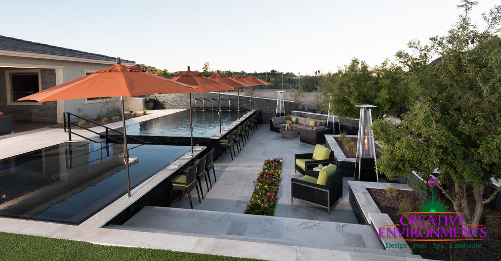 Inspiration for a huge modern backyard stamped concrete and custom-shaped infinity home design remodel in Phoenix