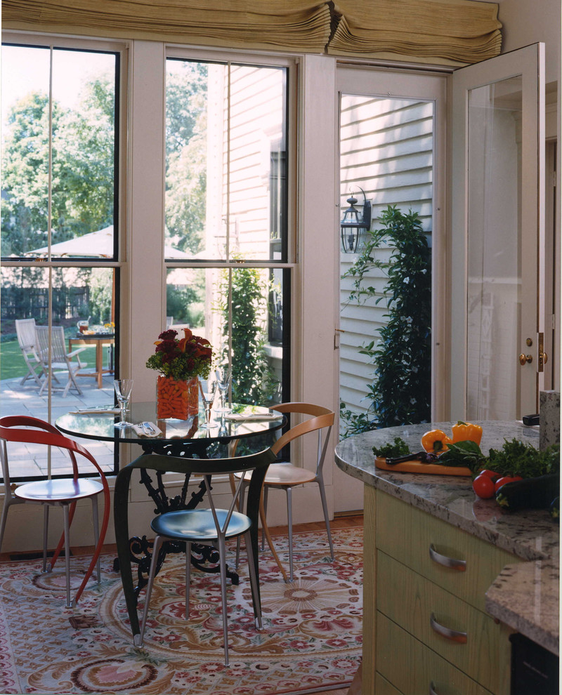 Example of a mid-sized transitional u-shaped medium tone wood floor eat-in kitchen design in Boston with an undermount sink, flat-panel cabinets, green cabinets, granite countertops, stainless steel appliances and no island
