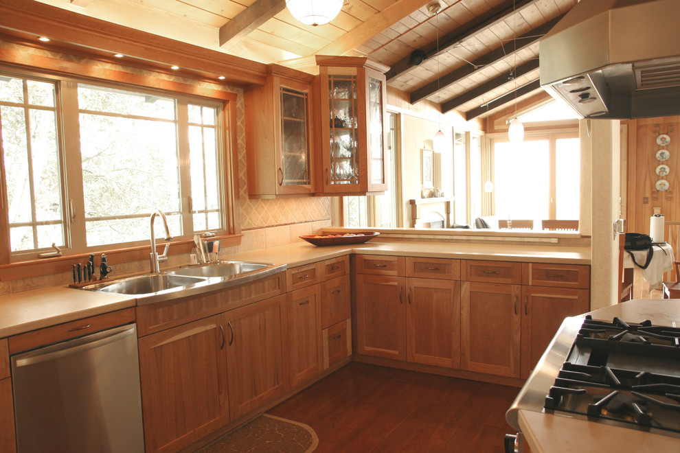 Enclosed kitchen - mid-sized transitional l-shaped medium tone wood floor enclosed kitchen idea in San Francisco with an undermount sink, shaker cabinets, medium tone wood cabinets, granite countertops, beige backsplash, stone tile backsplash and stainless steel appliances