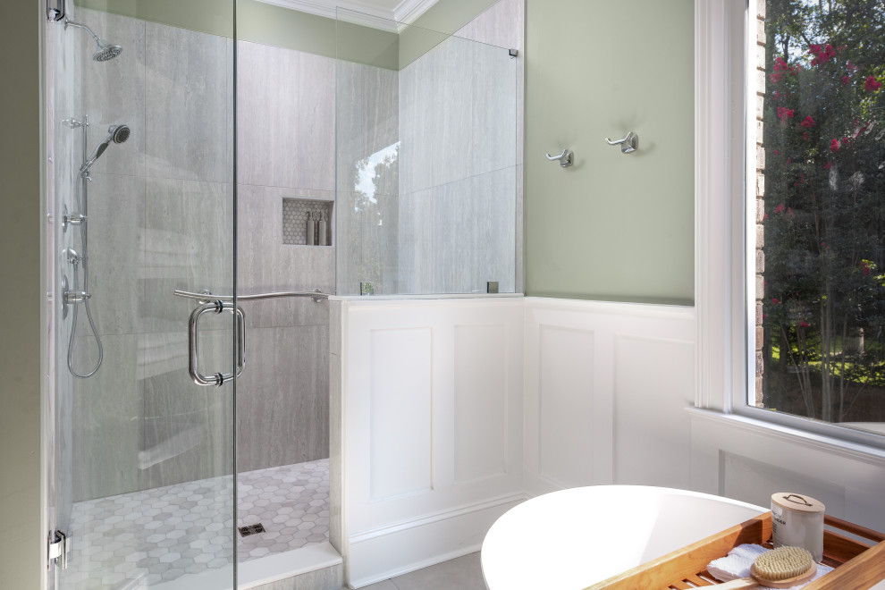 Inspiration for a mid-sized transitional master gray tile and porcelain tile porcelain tile, gray floor and double-sink freestanding bathtub remodel with flat-panel cabinets, white cabinets, a two-piece toilet, green walls, an undermount sink, quartz countertops, a hinged shower door, white countertops and a built-in vanity