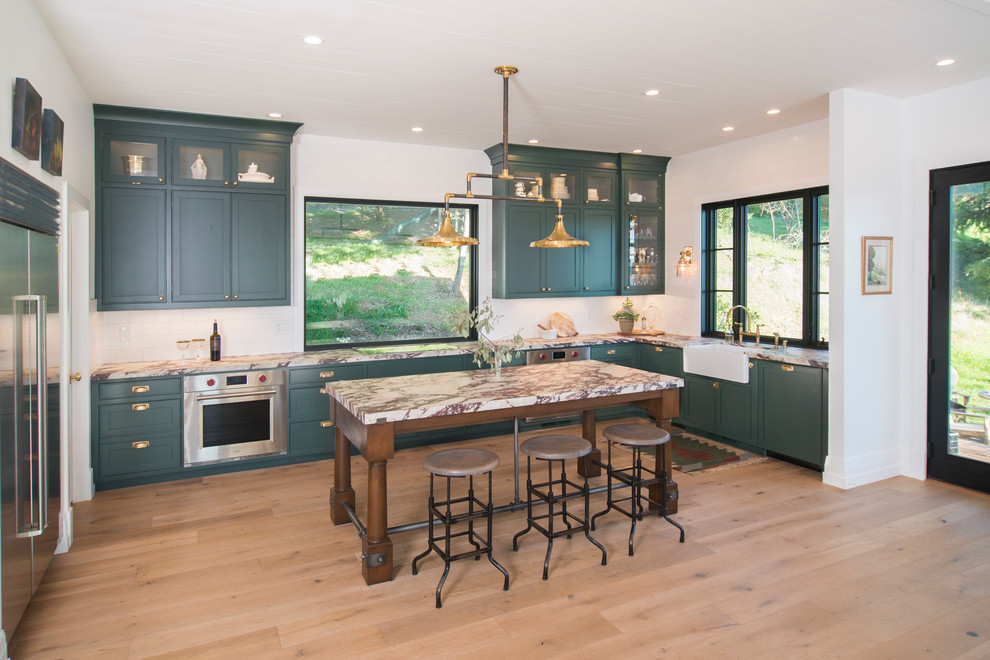 This is an example of a transitional l-shaped kitchen in San Francisco with green cabinets and beaded inset cabinets.