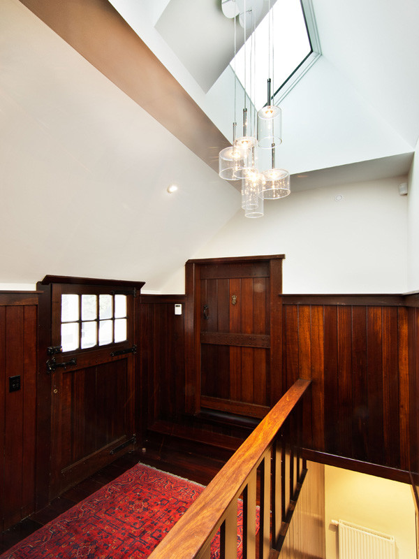 This is an example of a mid-sized transitional hallway in Wellington with white walls and dark hardwood floors.