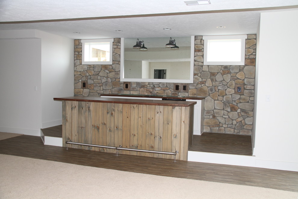 Mid-sized country galley wet bar in Other with an undermount sink, granite benchtops, brown splashback, stone tile splashback and ceramic floors.