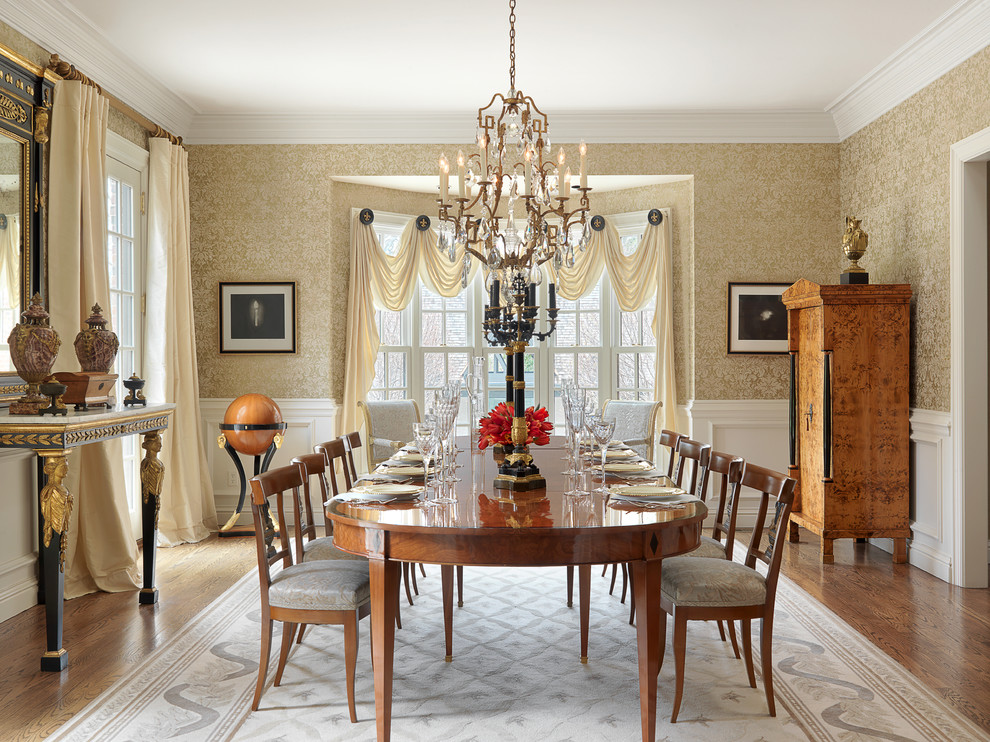 Design ideas for a large traditional separate dining room in St Louis with yellow walls and medium hardwood floors.