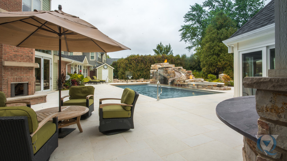 Large mountain style backyard rectangular lap water slide photo in Chicago