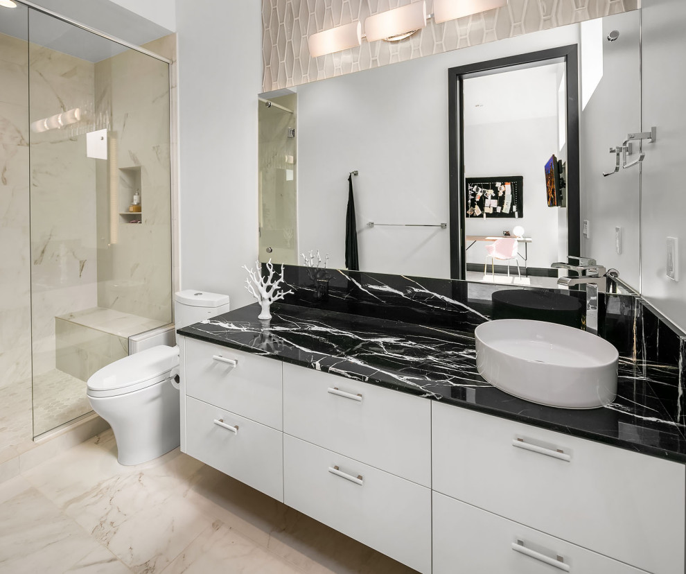 Inspiration for a mid-sized contemporary 3/4 bathroom in Denver with flat-panel cabinets, white cabinets, an alcove shower, a two-piece toilet, beige tile, white walls, a vessel sink, beige floor, black benchtops, a niche, a shower seat, a single vanity and a floating vanity.
