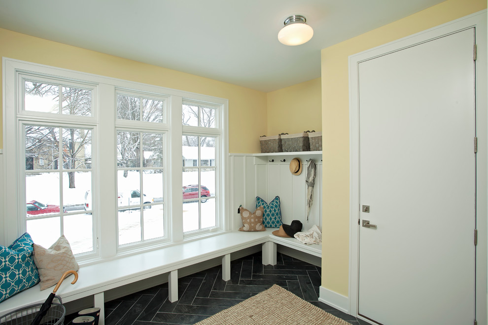 Transitional mudroom in Minneapolis with yellow walls.