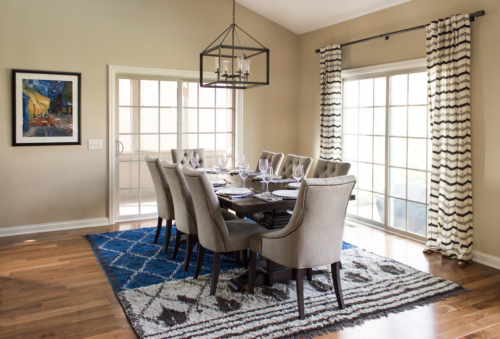 Example of a classic medium tone wood floor dining room design in Columbus with beige walls