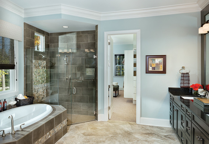 Large transitional master bathroom in Tampa with an undermount sink, recessed-panel cabinets, dark wood cabinets, onyx benchtops, a double shower, a one-piece toilet, brown tile, ceramic tile, blue walls, ceramic floors and a drop-in tub.