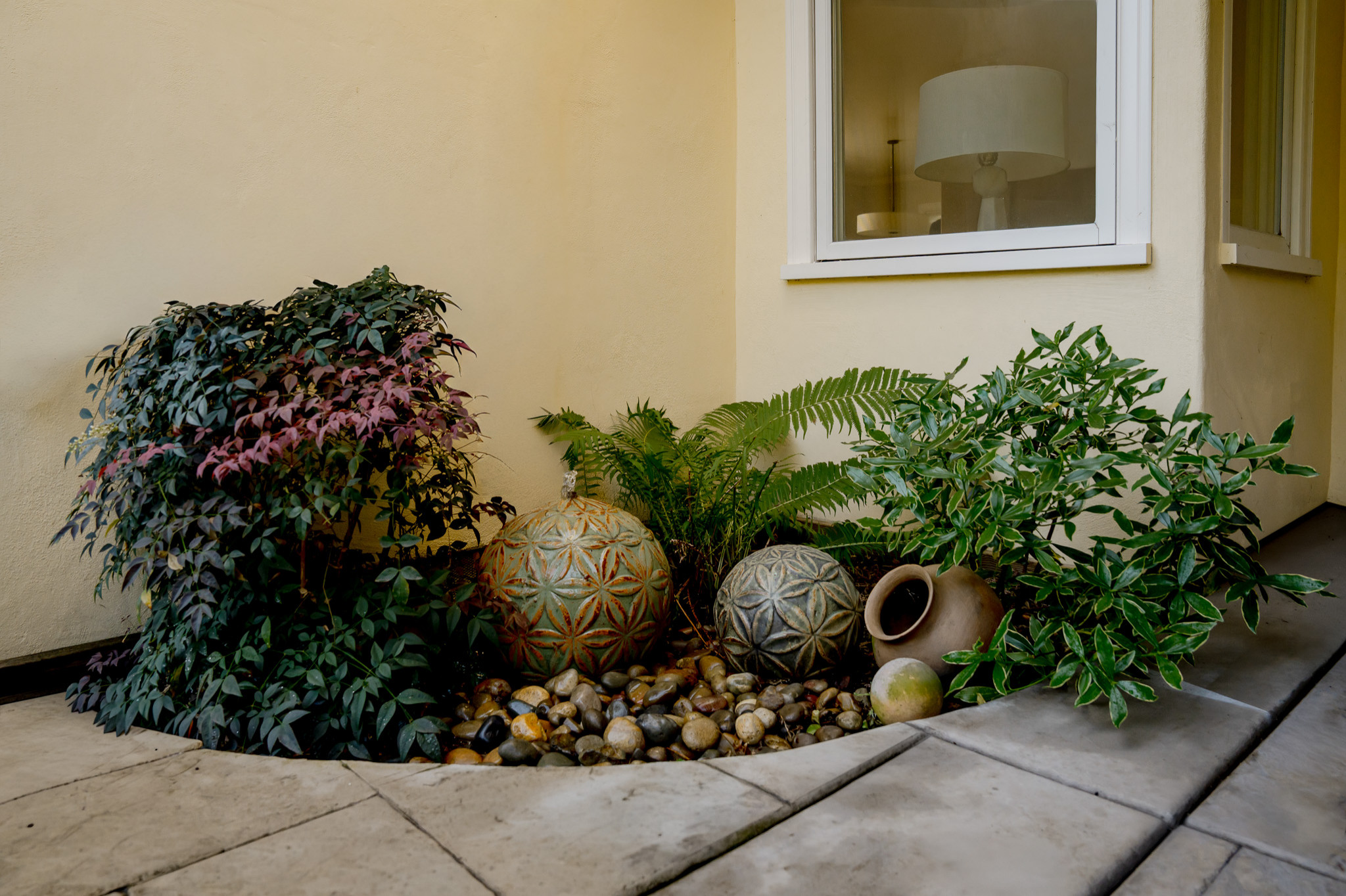 Sculptural Fountain with Ferns, Nandina, and Daphne