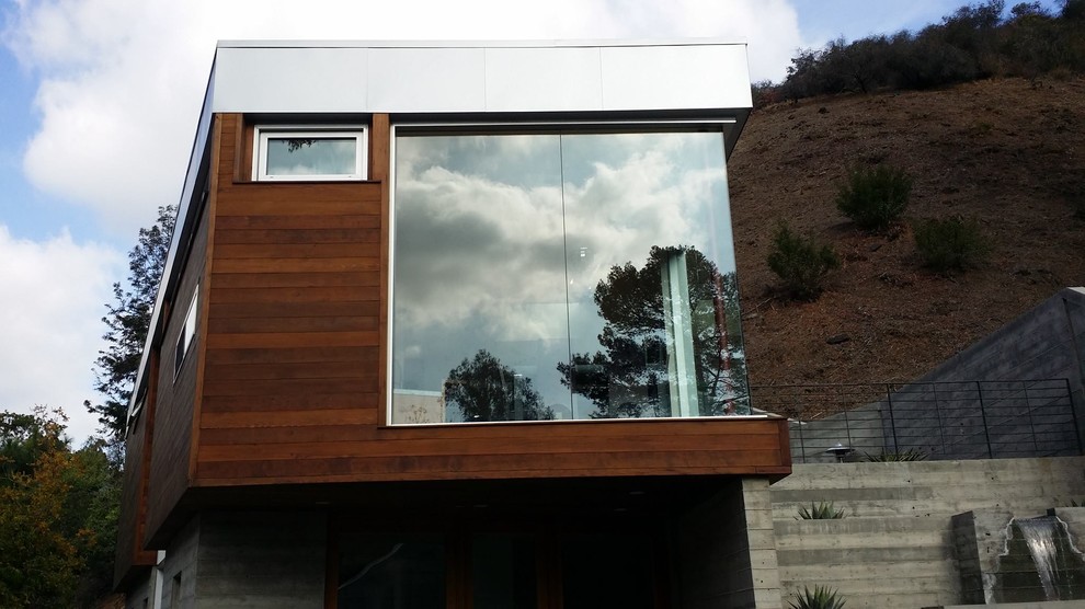 Large modern brown two-story wood exterior home idea in Los Angeles