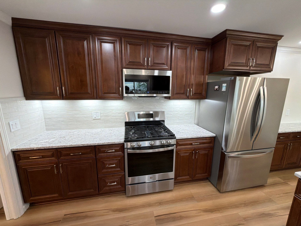 USCD cabinetry accompanied granite countertops, porcelain tile backsplash and Ca